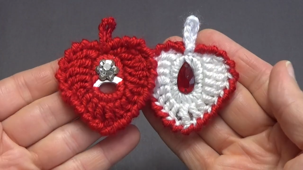 Beautiful beaded heart on crochet background – design closeup